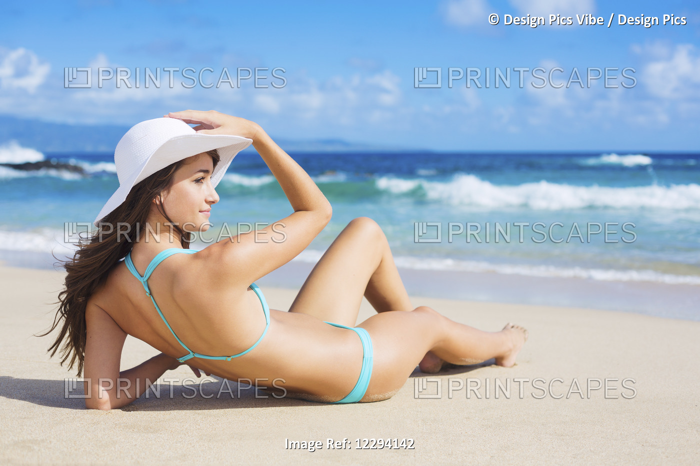 Beach Vacation. Beautiful Young Woman In Sun Hat Relaxing On The Beach.