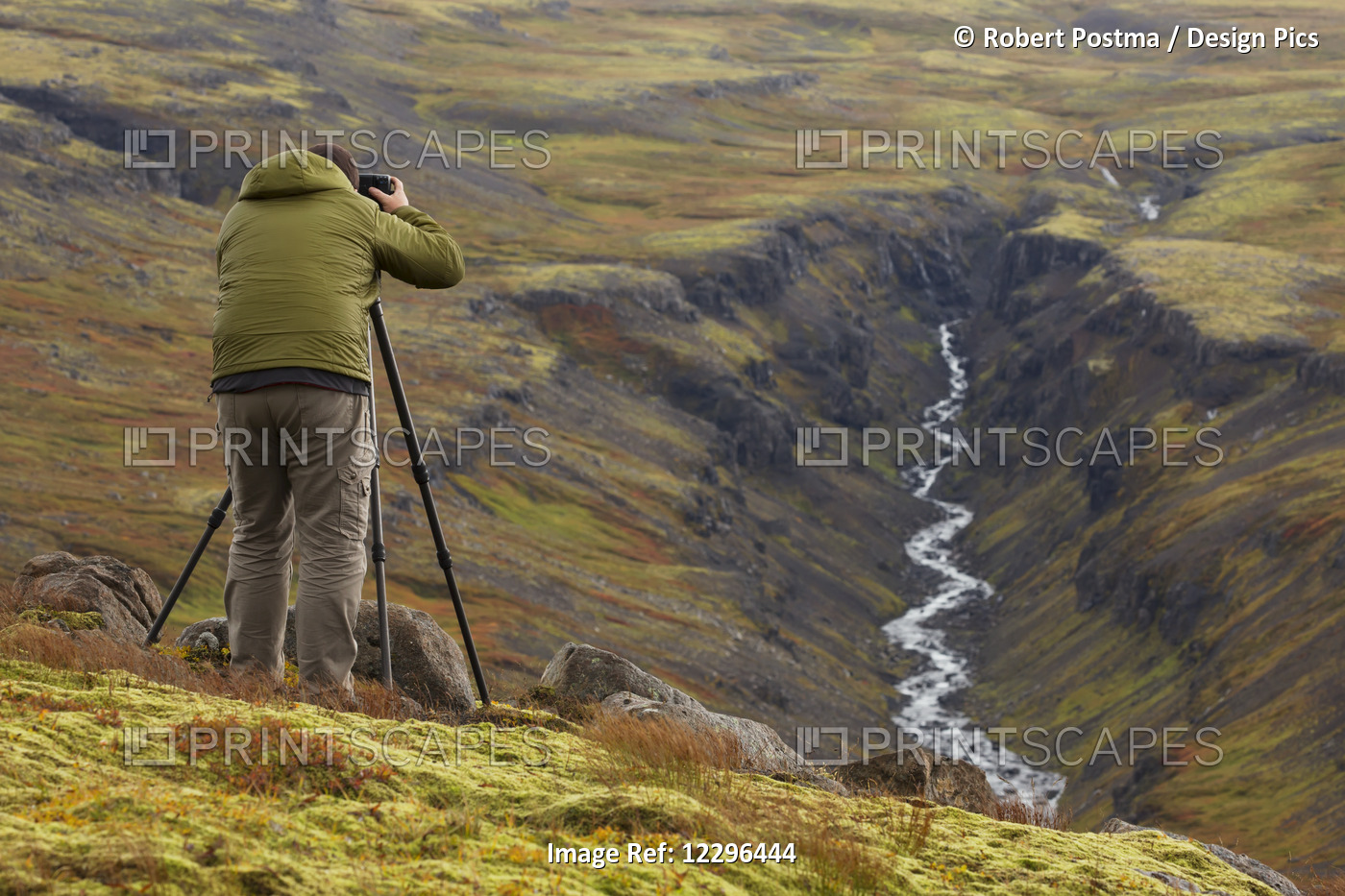 Man Photographing A River Valley In Iceland During Autumn; Iceland