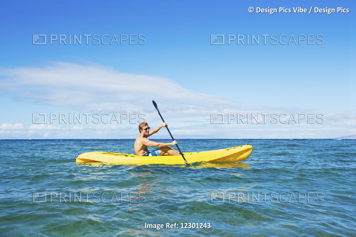 Man Kayaking In The Tropical Ocean