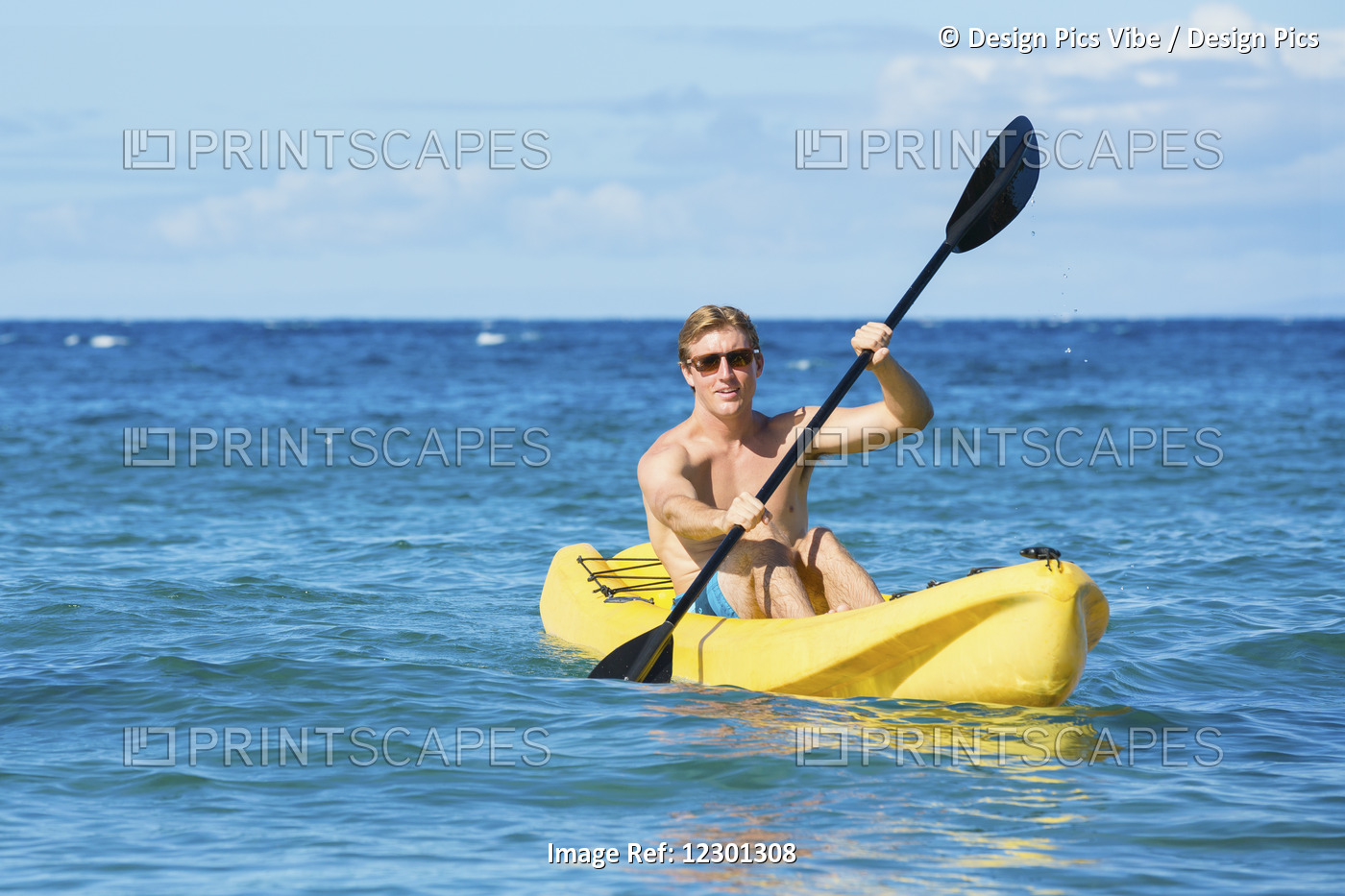 Man Kayaking In The Tropical Ocean In Yellow Kayak On Sunny Morning In Hawaii