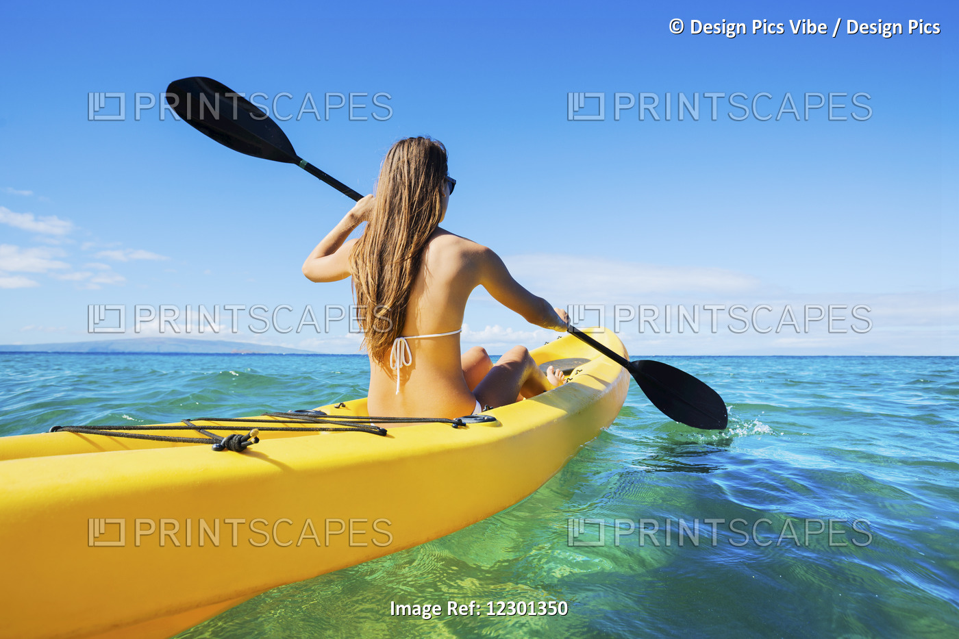 Woman Kayaking In The Ocean On Vacation In Hawaii