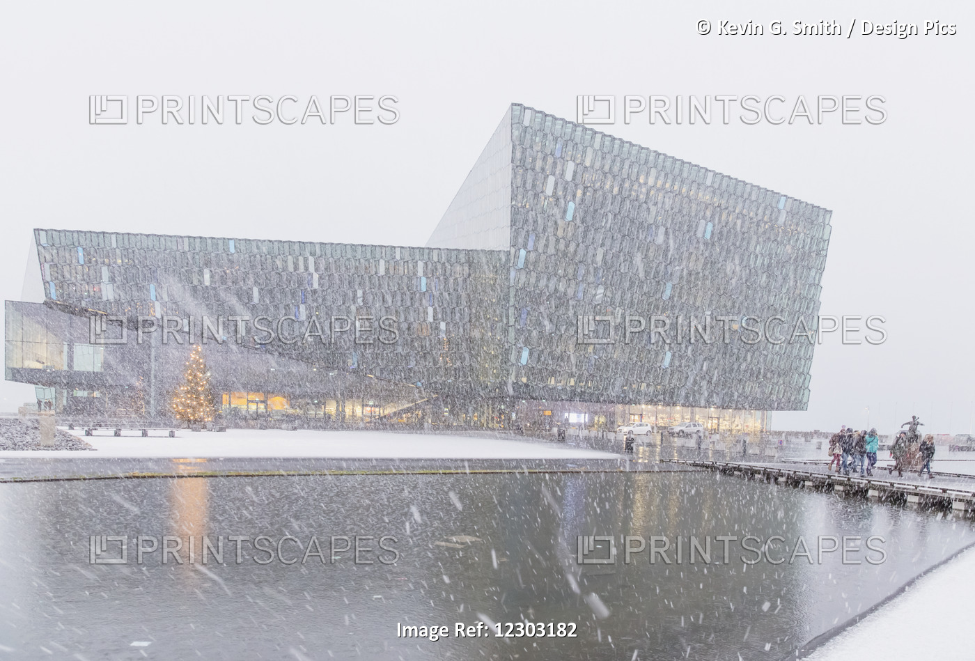 People Walking Outside Of The Harpa Public Concert Hall During A Snow Storm, ...