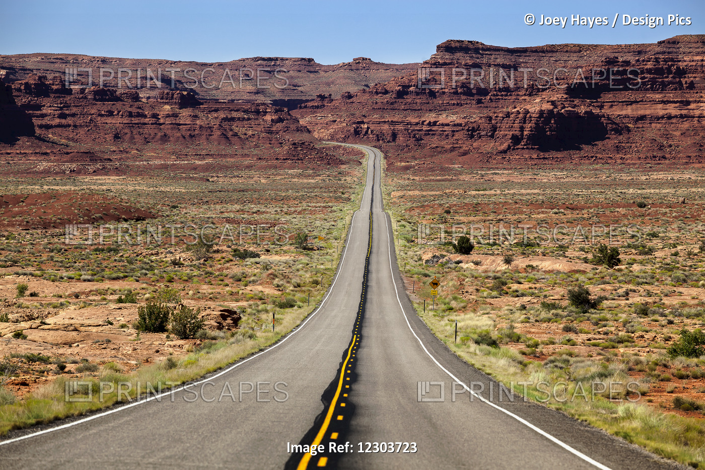 Utah Highway Stretching Into The Distance With Rock Cliffs And Blue Skies In ...