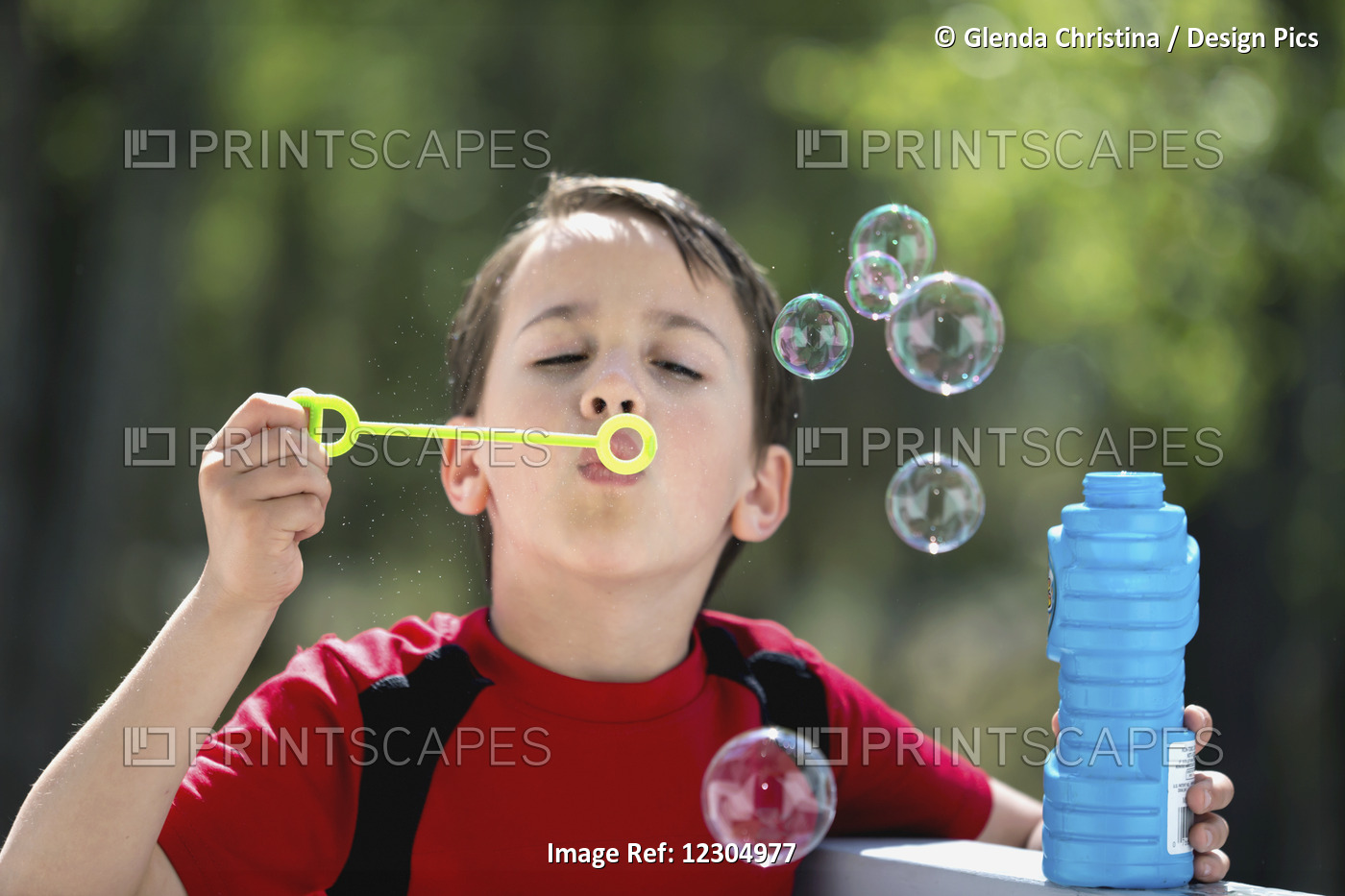 Boy Playing With And Blowing Bubbles In Summer, Palmer, Southcentral Alaska.