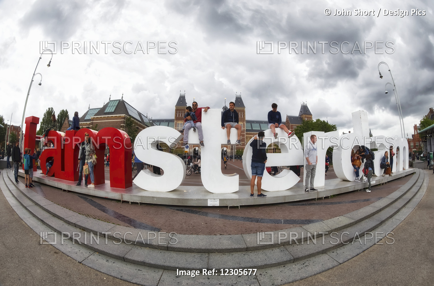 People Standing And Sitting On The Lettering Spelling The Word 'amsterdam'' ...