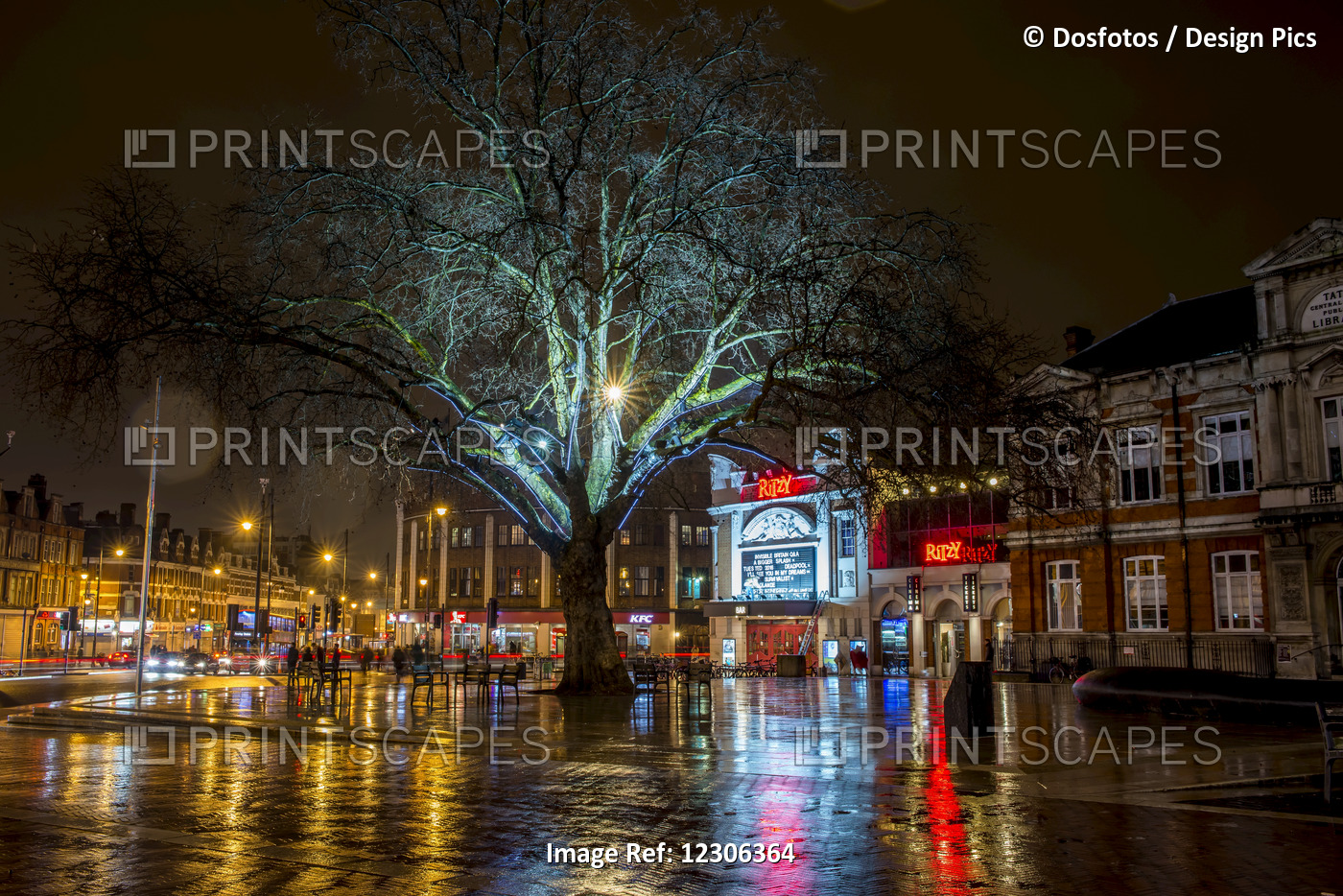 Lights Illuminate Buildings And Are Reflected On The Wet Street, Brixton, South ...