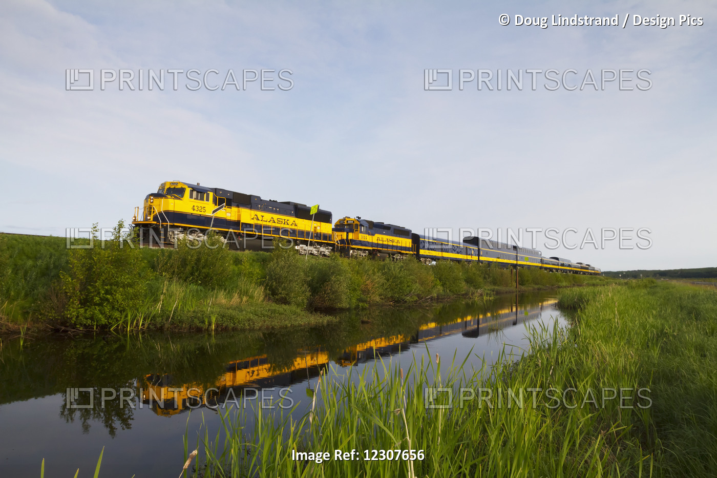 An Alaska Railroad Passenger Train Is Reflected In A Pond Across The Seward Hwy ...