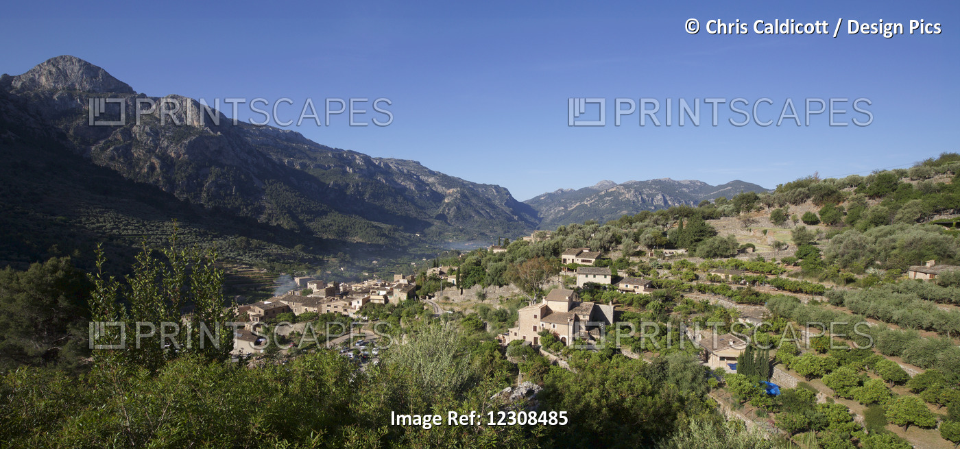 Landscape View Of Hillside Village Backed By Mountains, Mallorca