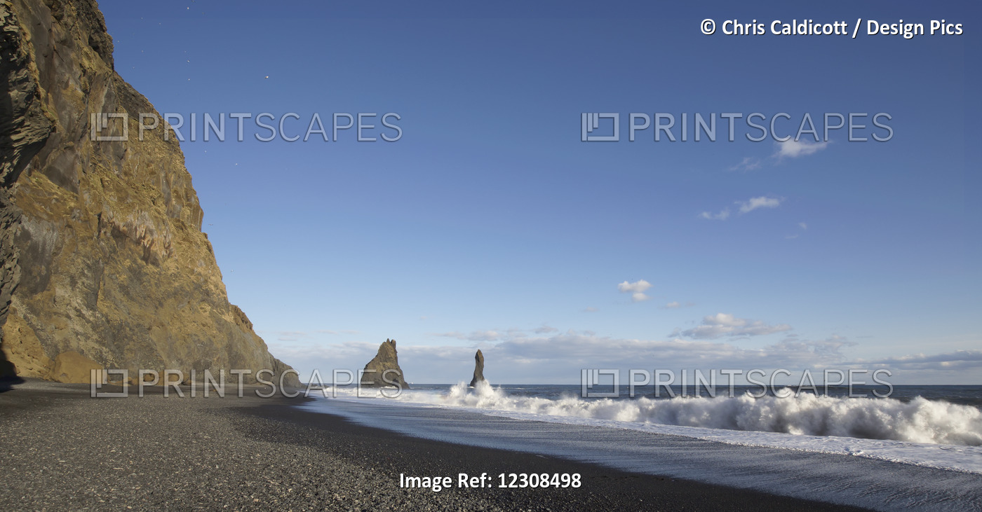 Waves Crashing On Black Sand Beach With Giant Off Shore Stack Pillars