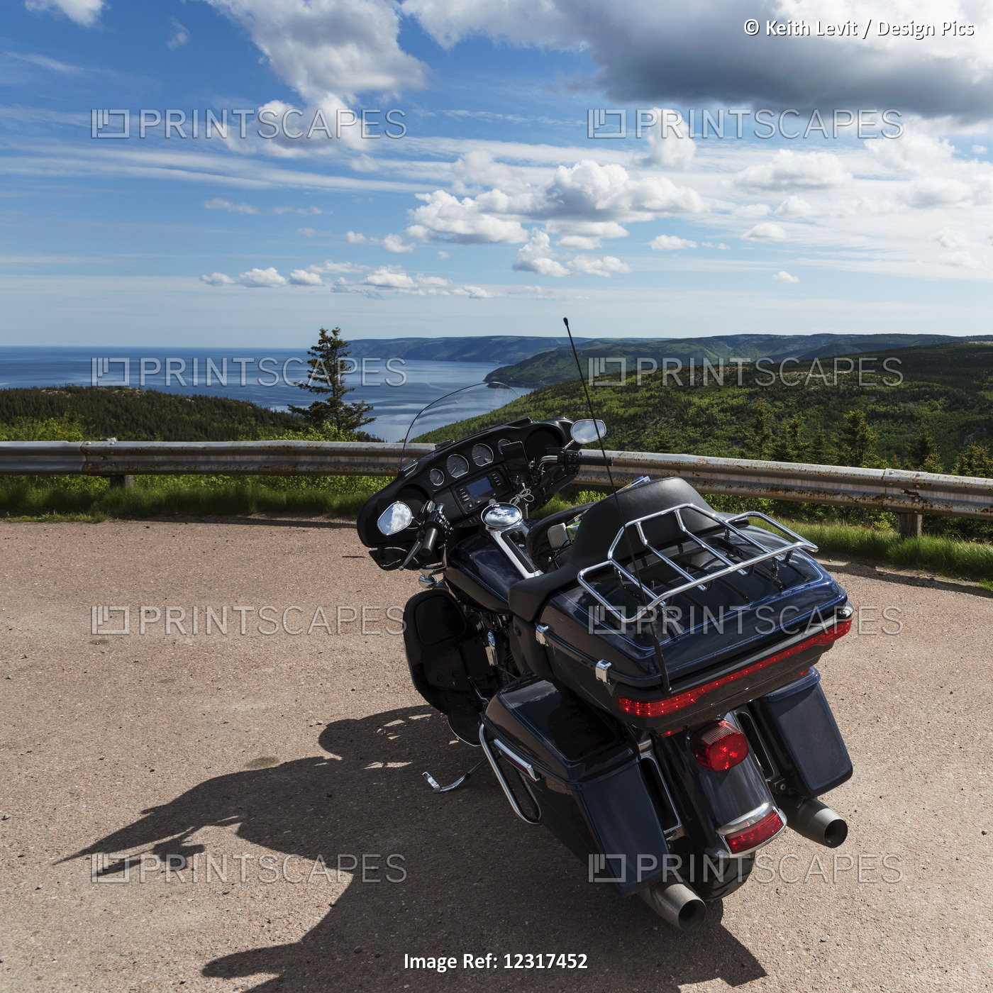 A Motorcycle Parked At A Roadside Lookout With A View Of The Coastline And ...