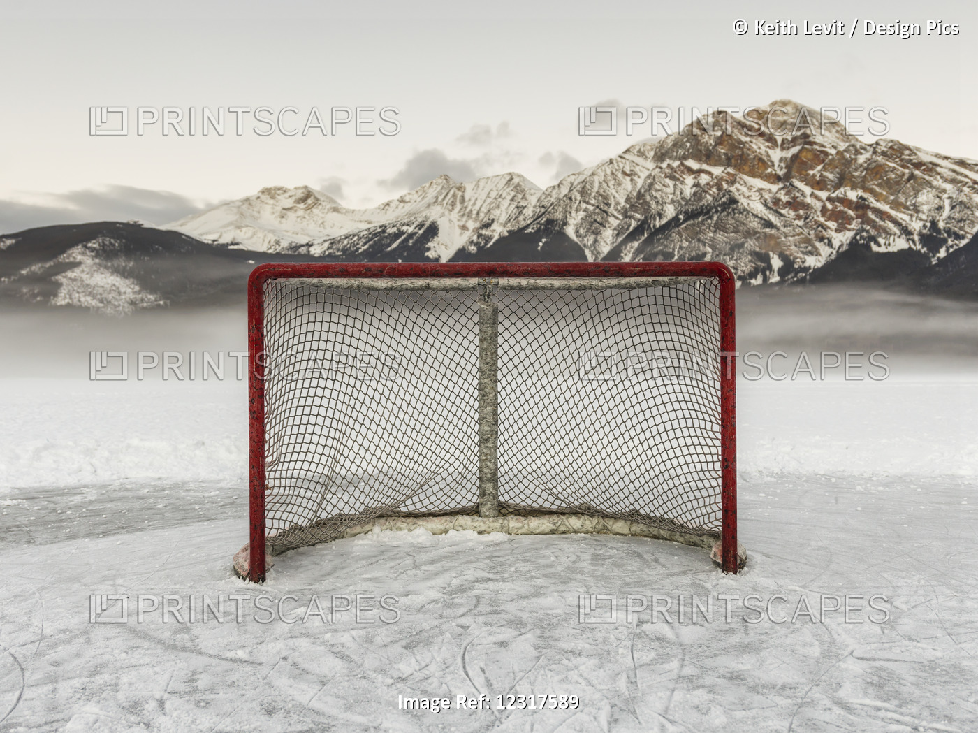 A Hockey Net On Frozen Pyramid Lake With The Rugged Canadian Rockies Mountain ...