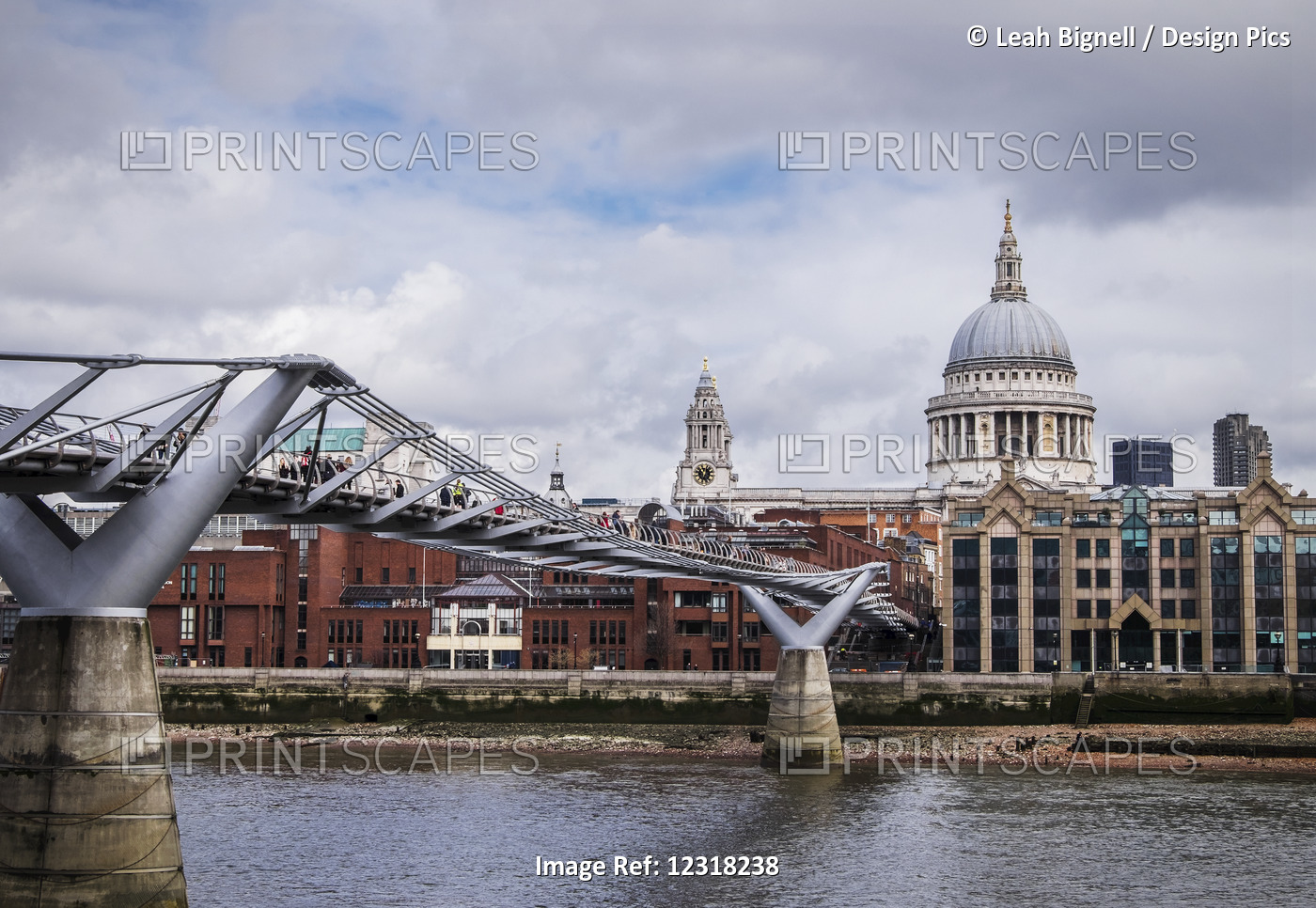 View of the Millennium Bridge and St Paul's Cathedral from bankside of River Thames; London, England