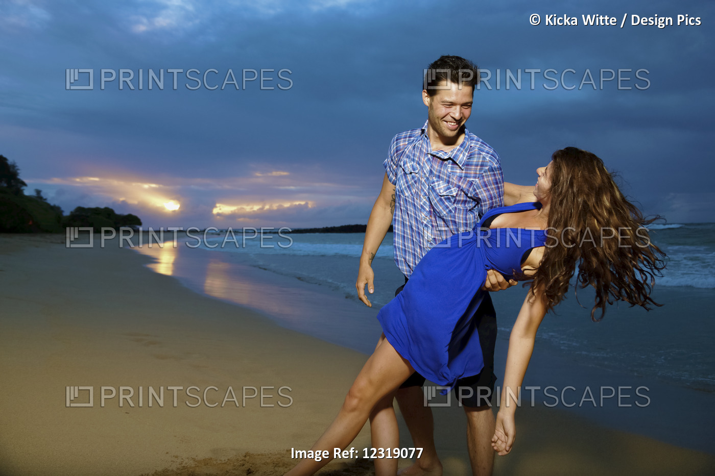 Couple On A Beach; Kealia, Kauai, Hawaii, United States Of America