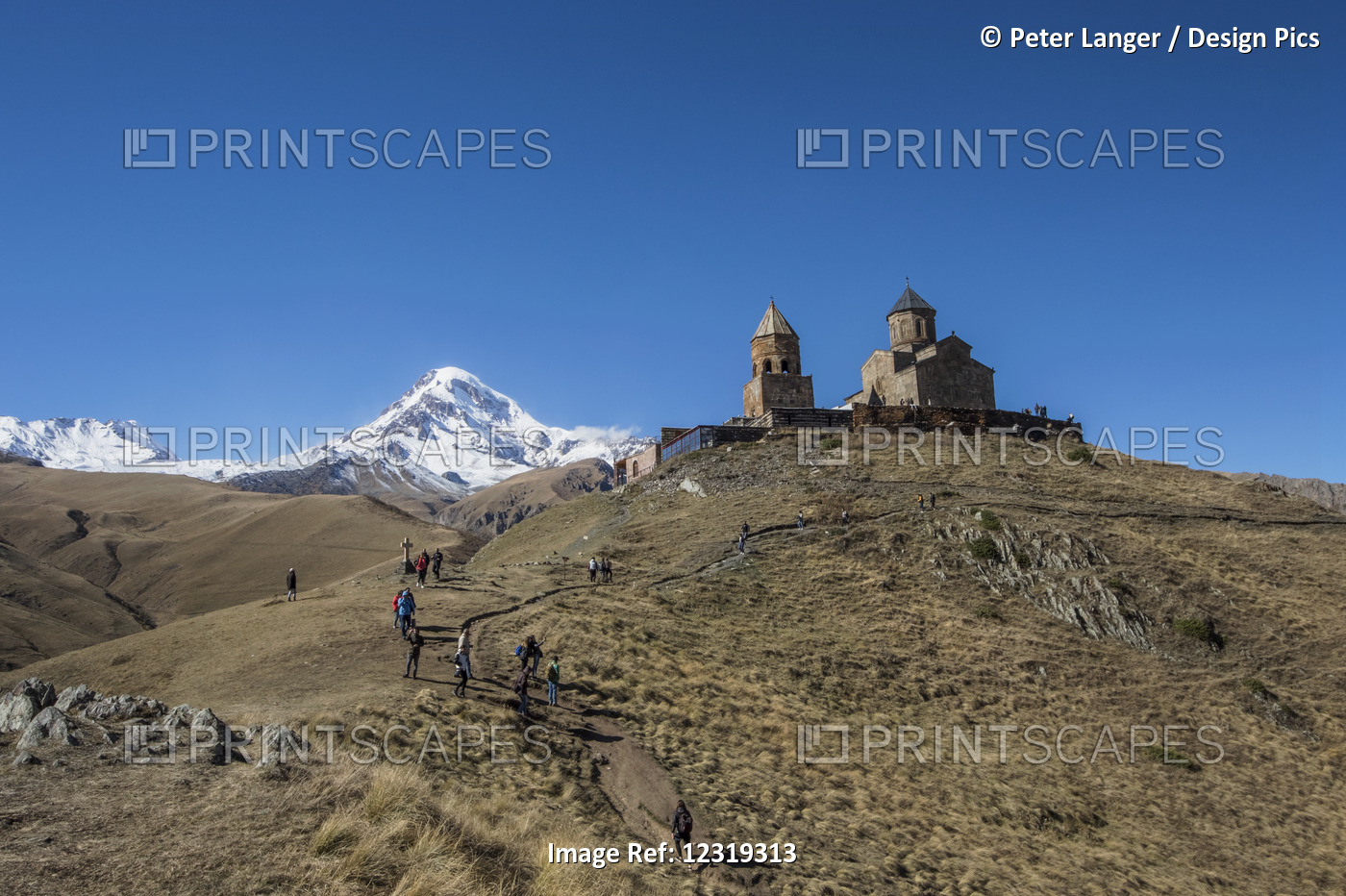 Gergeti Trinity Church With The Caucasus Mountains In The Background; Kazbegi, ...