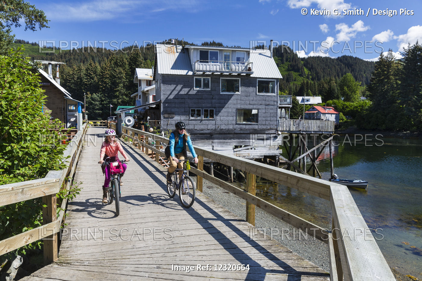 Mother And Daughter Ride Bicycles On The Historic Oceanside Boardwalk In ...