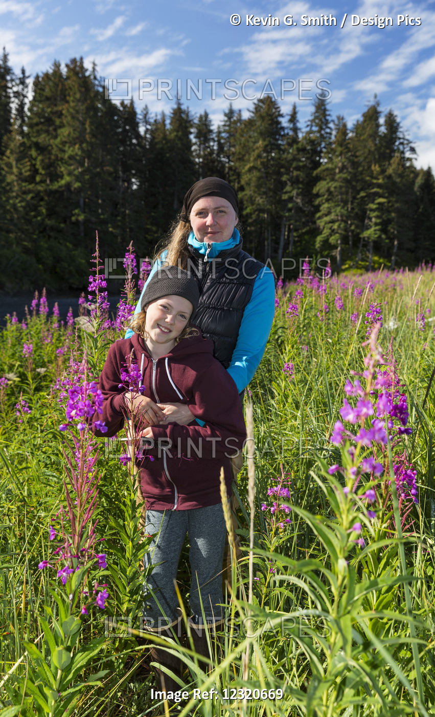 Mother And Daughter Standing In A Field Of Tall Fireweed, Seldovia, ...