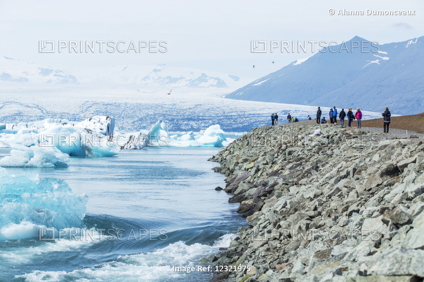 A Group Of Tourists Stands At The Edge Of A Viewpoint At Glacier Lagoon, ...