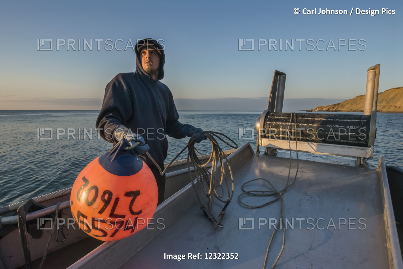 Commercial Fishing Boat Crewman Prepares To Toss A Buoy Into The Waters Of ...