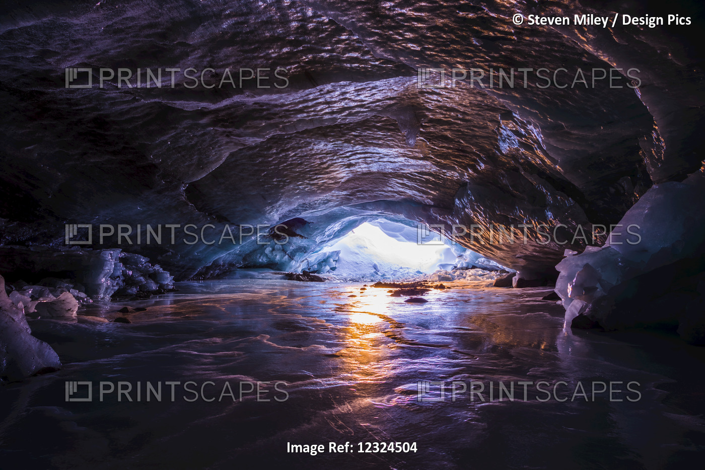 The Colors Of Sunset Reflect Off The Ice Inside An Ice Cave Within Augustana ...