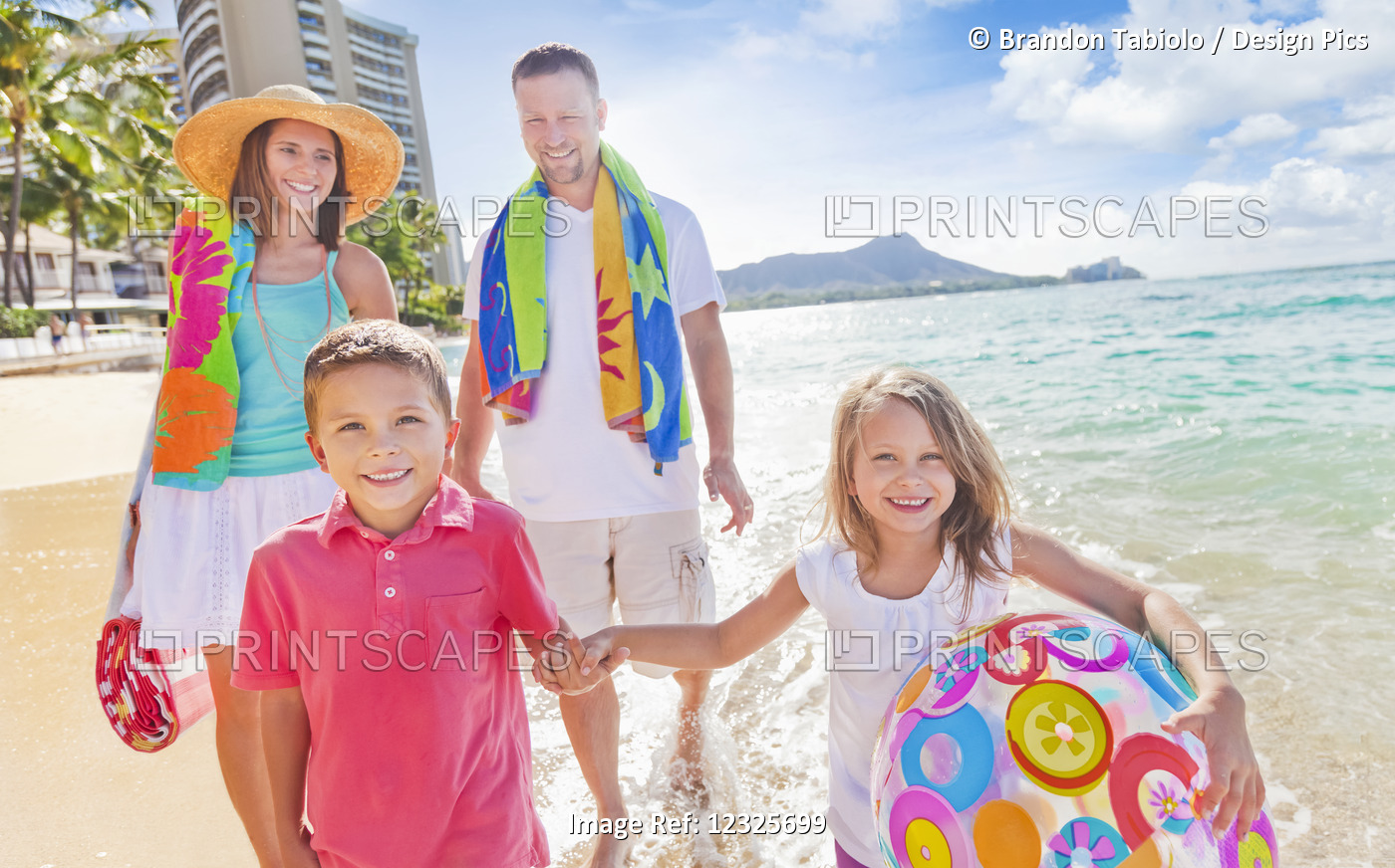 Family Of Four Enjoying A Summer Vacation In Waikiki Beach; Waikiki, Oahu, ...