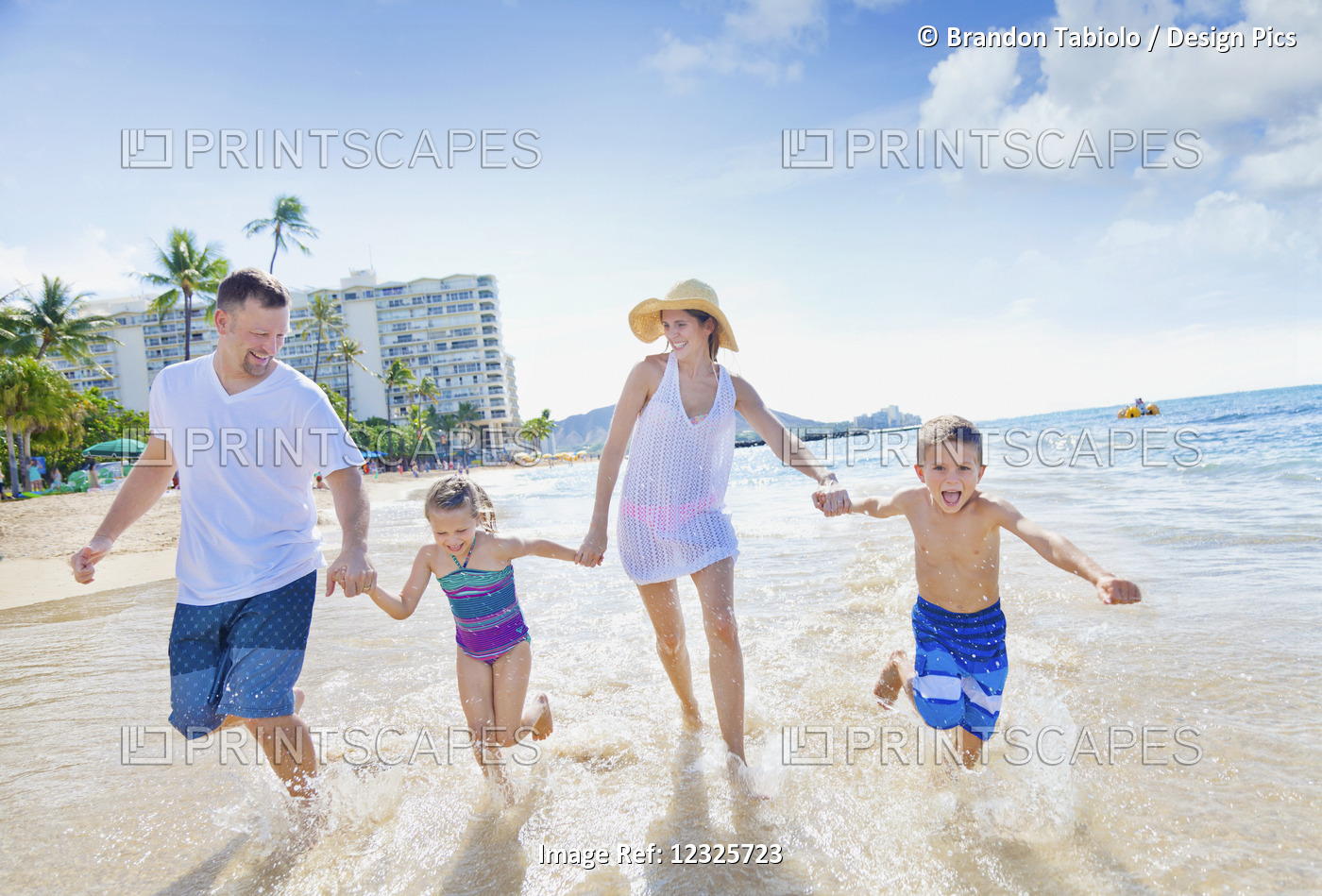A Family Of Four Enjoying A Summer Vacation In Waikiki Beach; Honolulu, Oahu, ...
