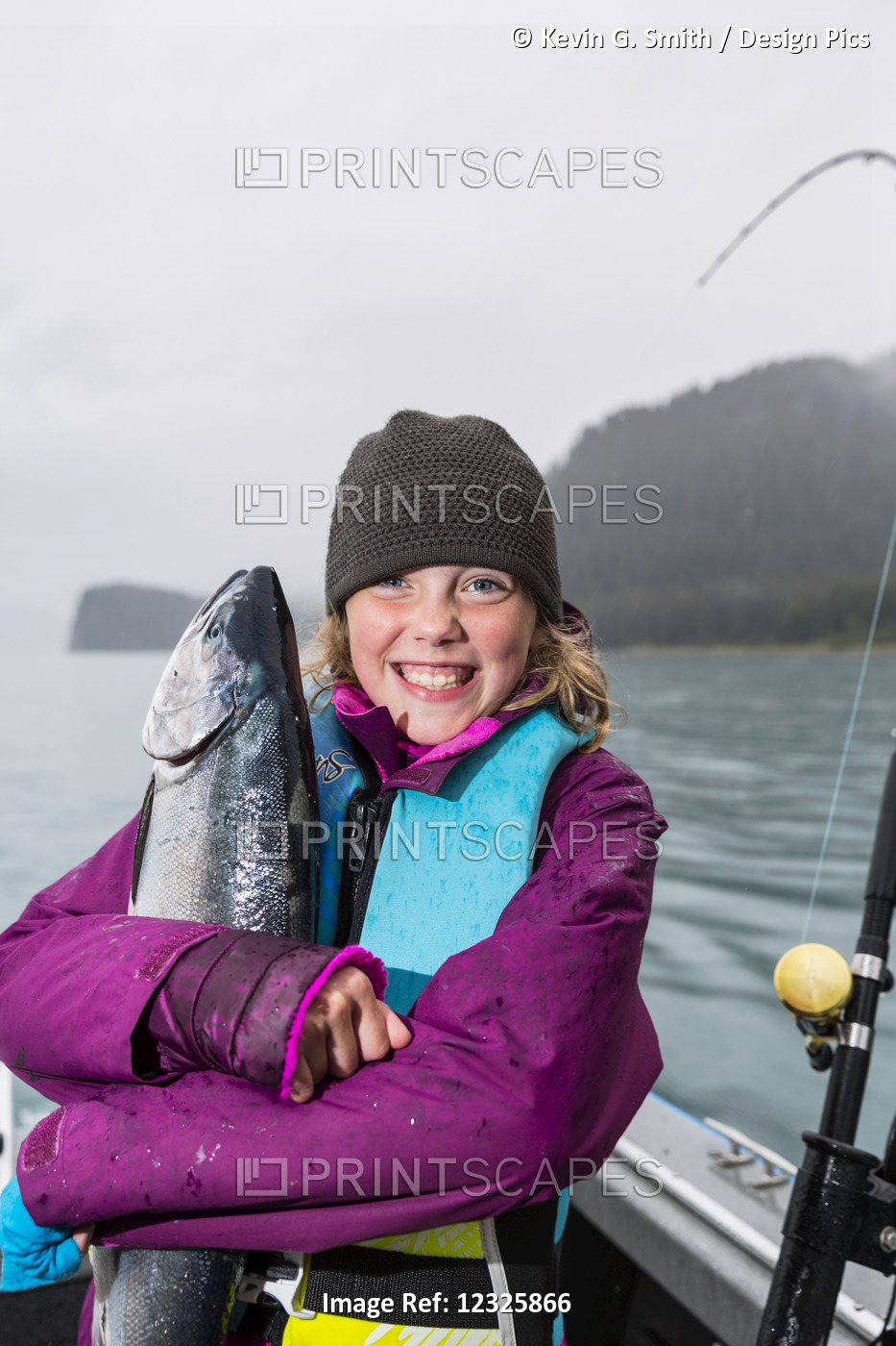 Young Girl Hugs A Silver Salmon While On A Fishing Boat, Seward, Southcentral ...