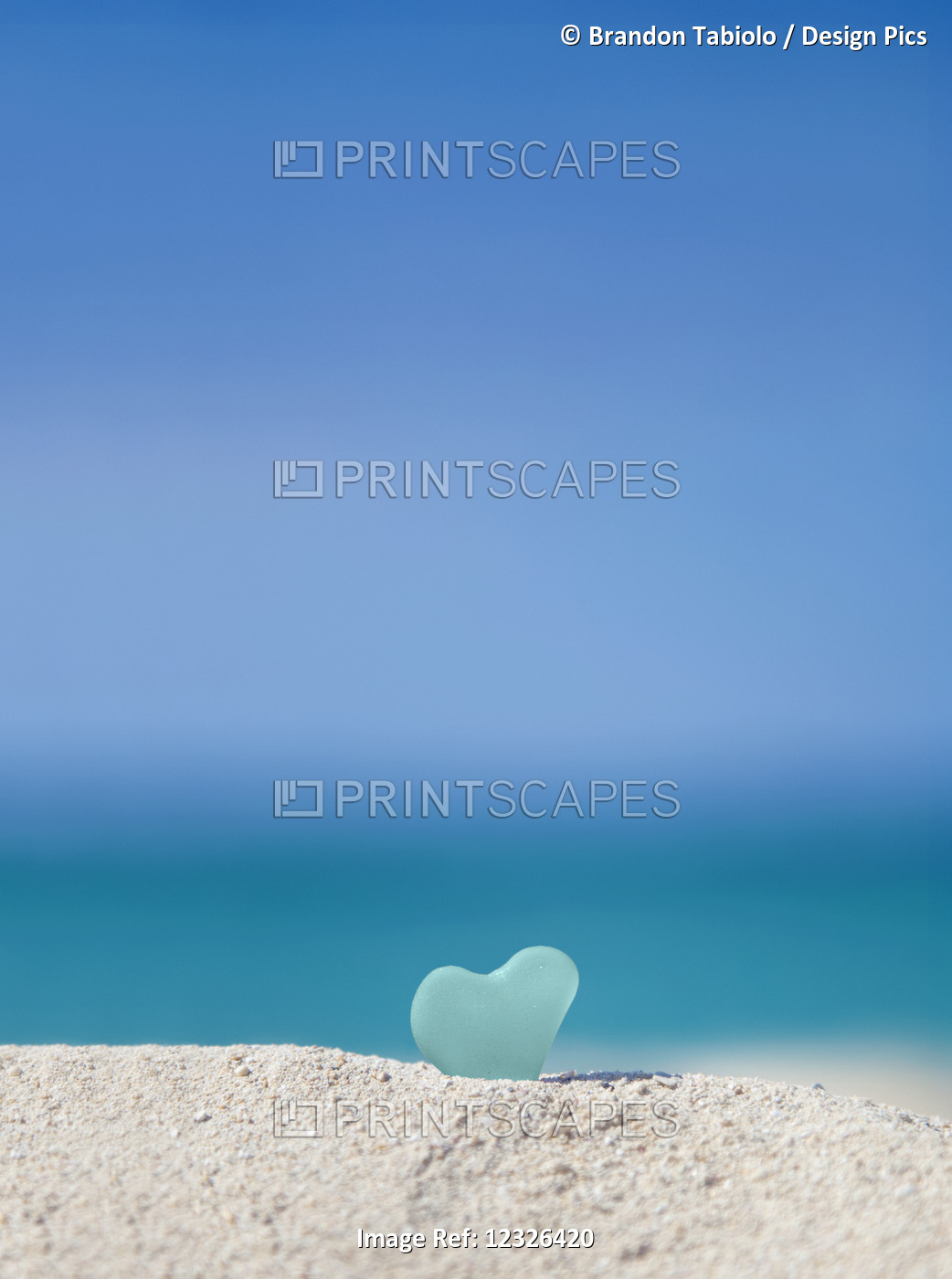 A Turquoise Heart Shaped Sea Glass In The Sand At The Beach; Honolulu, Oahu ...