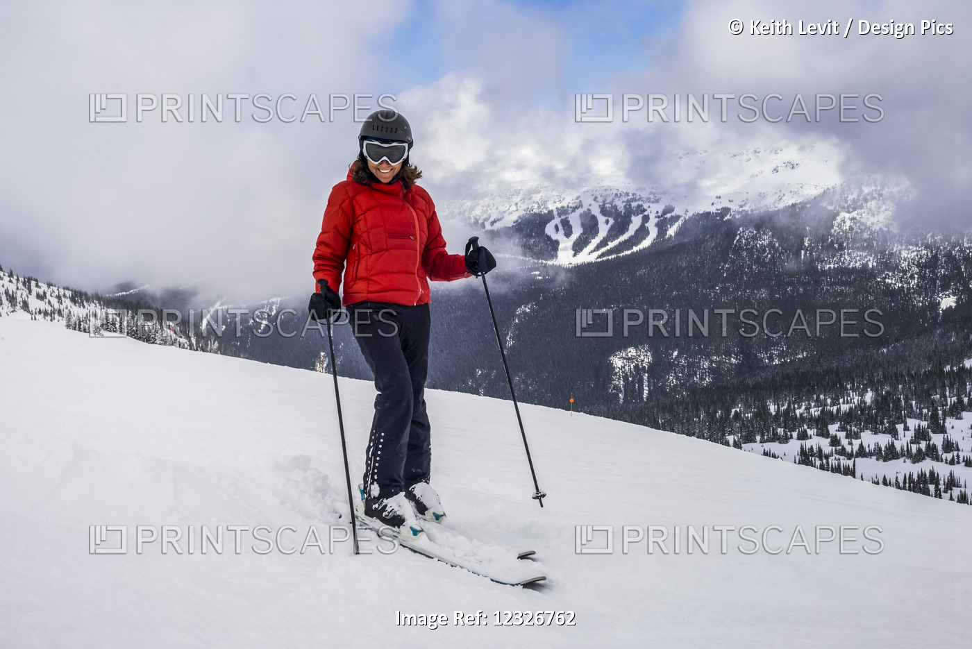 A Female Downhill Skier Poses For The Camera On A Ski Hill At A Ski Resort; ...
