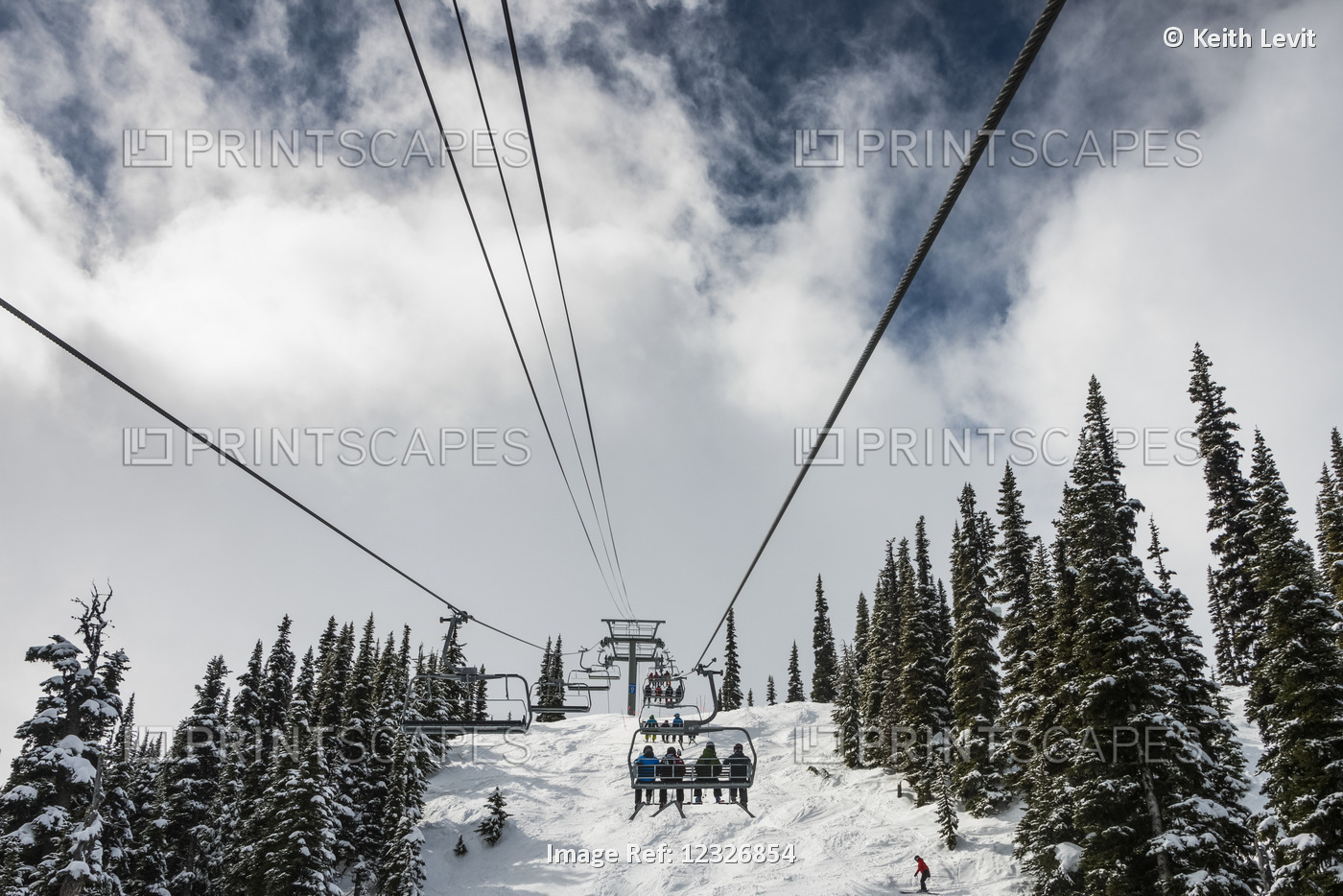 Downhill Skiers Riding A Chairlift At A Ski Resort; Whistler, British Columbia, ...