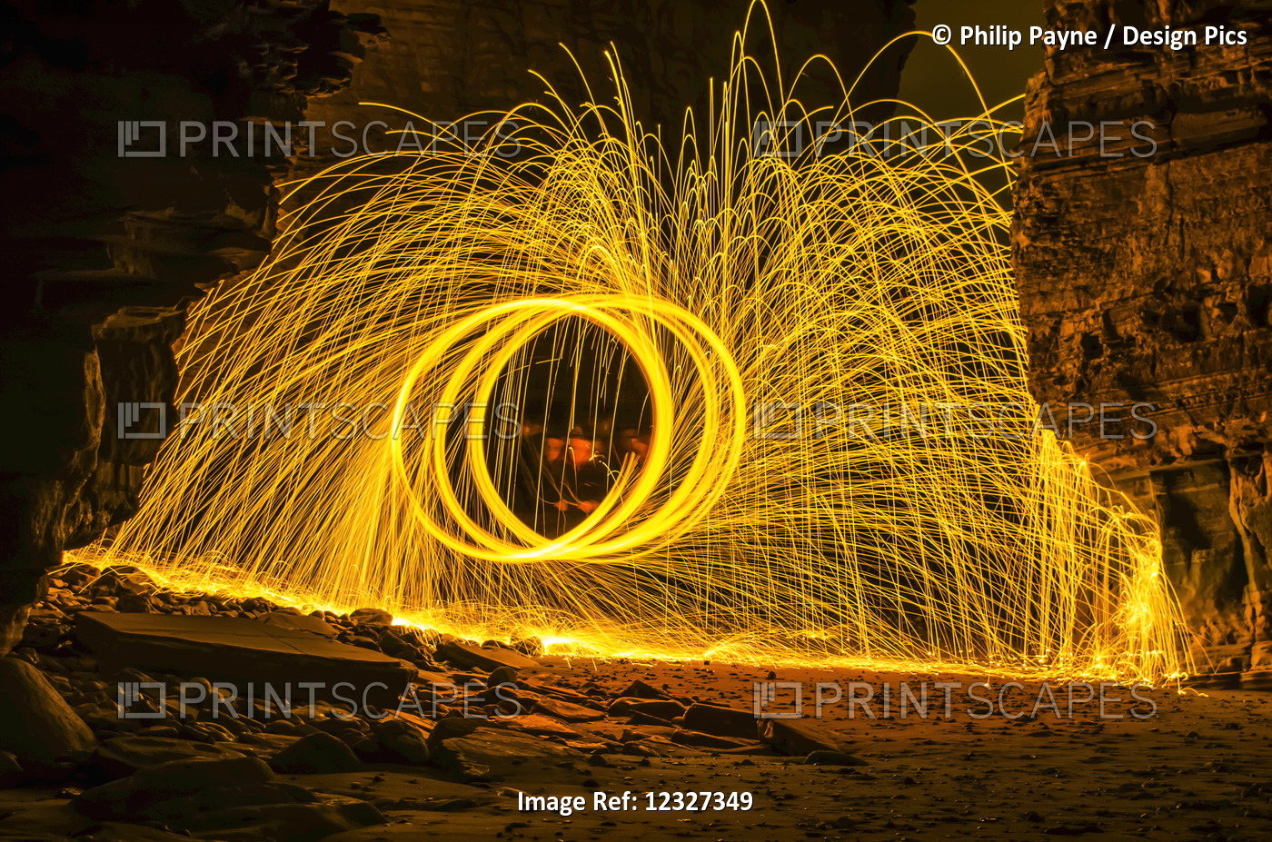 Bright Yellow Sparks Moving In A Circular Motion Off The Rocks; South Tyneside, ...