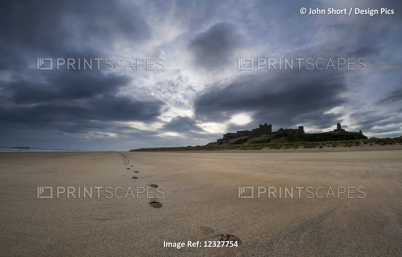 A Single Set Of Footprints On The Beach With Bamburgh Castle In The Background; ...