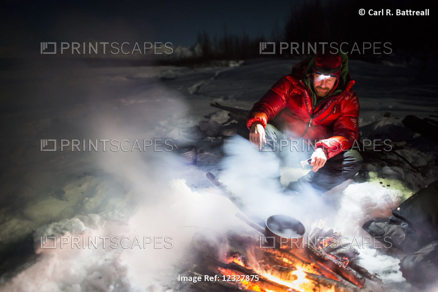 Man Cooking Over An Open Fire At Night In Winter, Denali State Park, ...