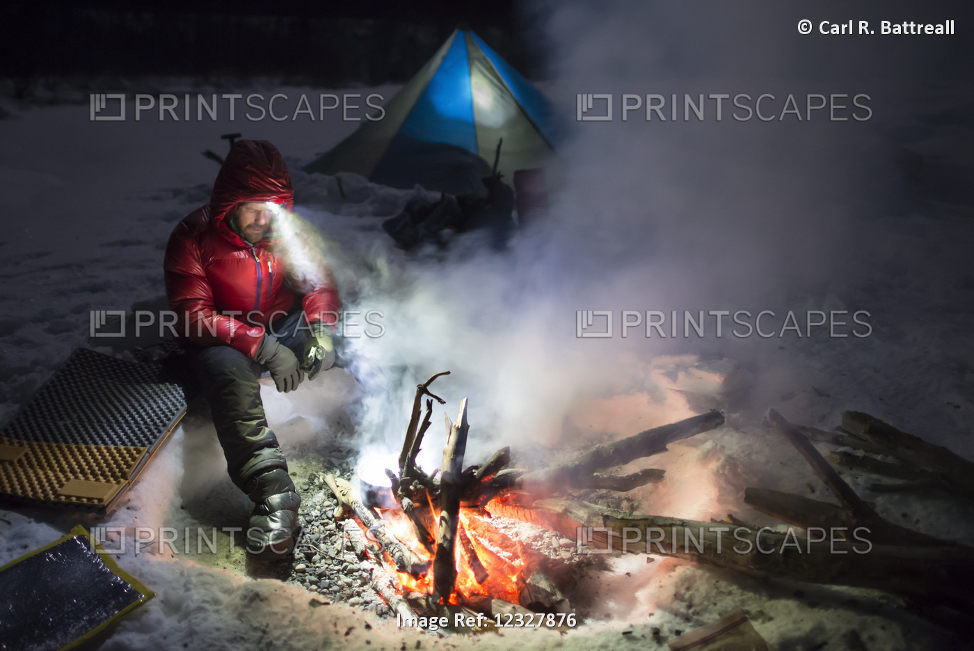 Man Cooking Over An Open Fire At Night In Winter, Denali State Park, ...