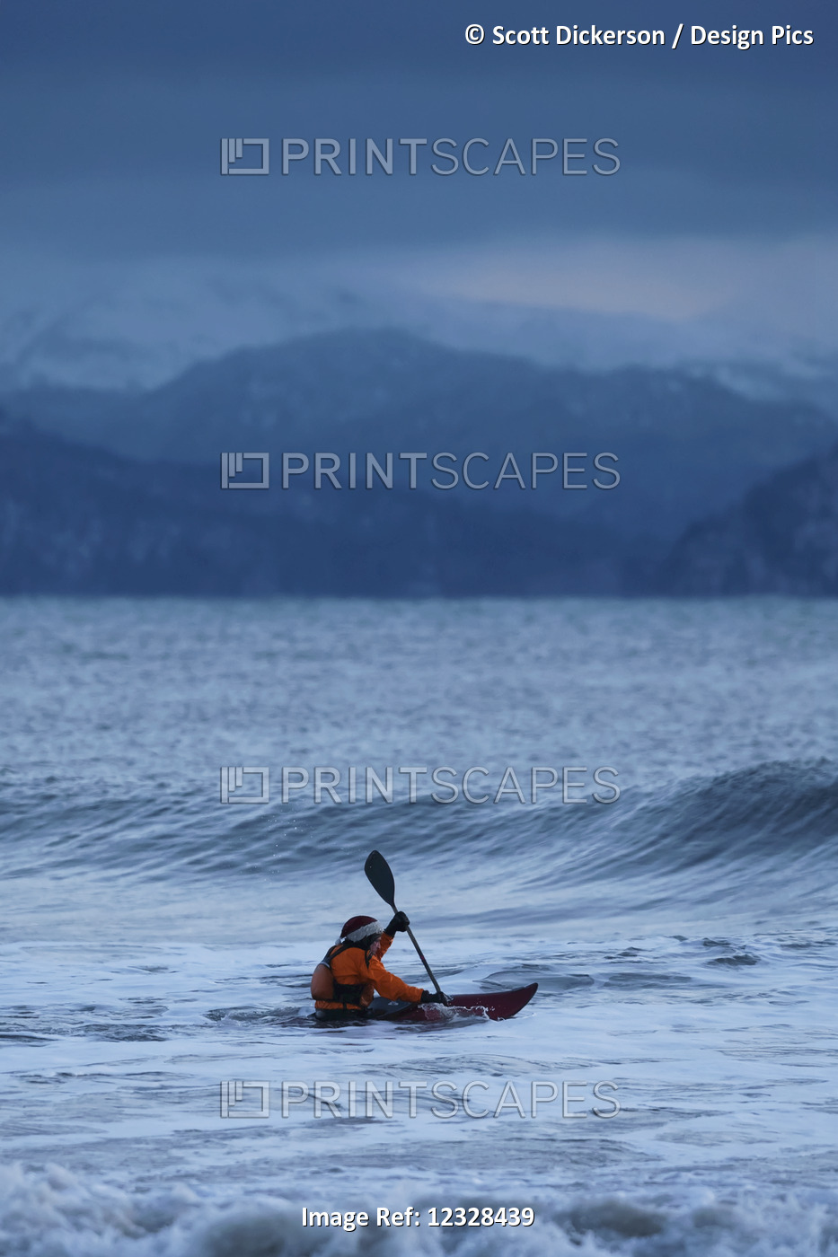 Kayak surfer approaching a wave in Kachemak Bay, Southcentral Alaska; Homer, ...
