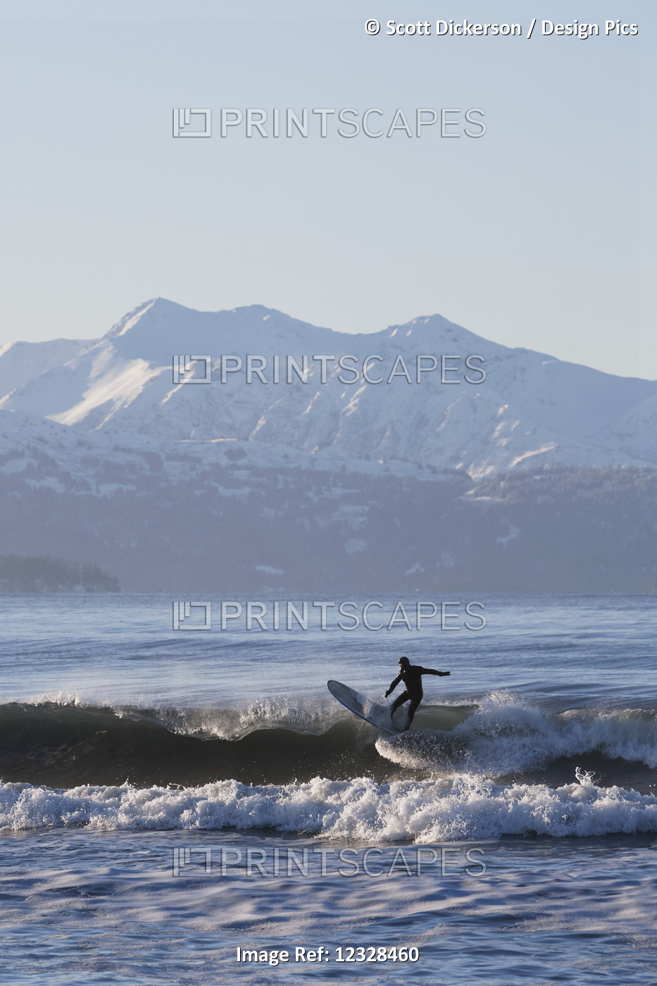 Man surfing in Kachemak Bay, South-central Alaska; Homer Spit, Alaska, United ...