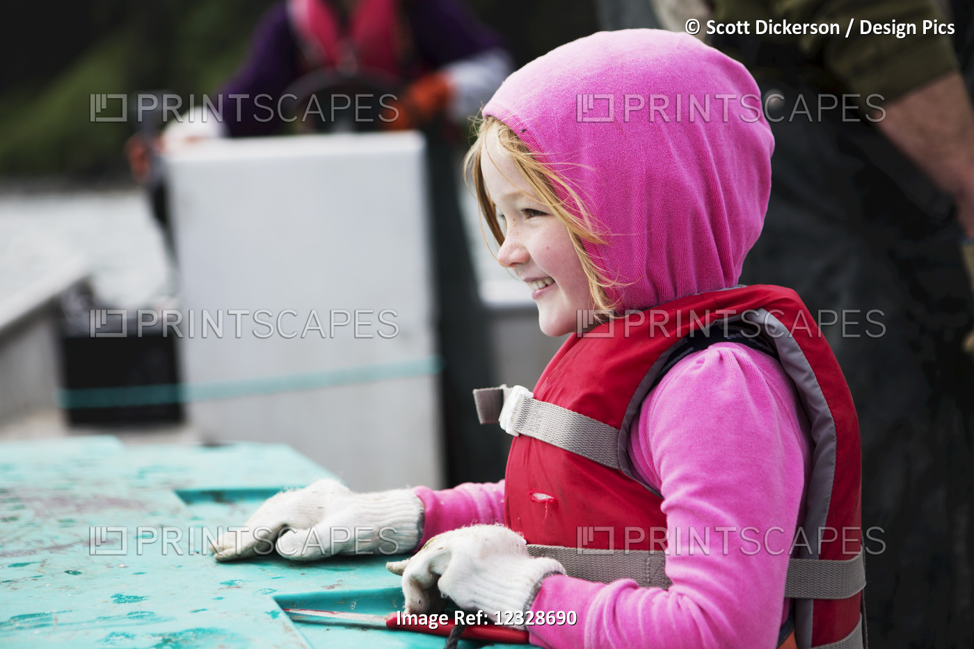 Young girl in her family's set-net skiff, Seldovia, South-central Alaska; ...