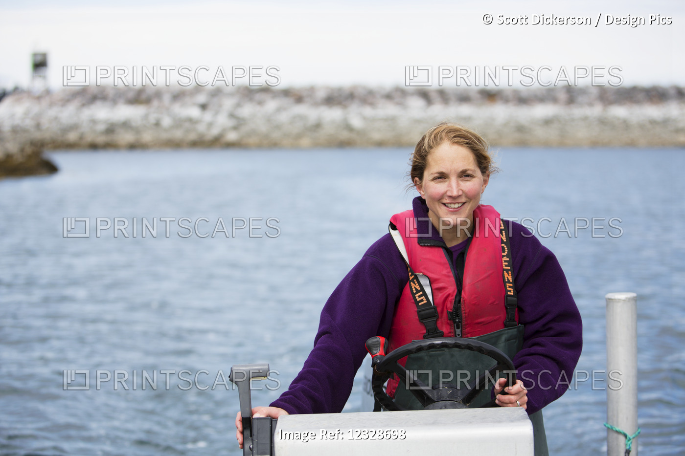 Woman set-netter drives a set-net skiff in Seldovia Bay, South-central Alaska; ...