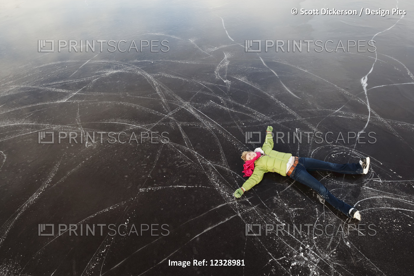 A Young Woman Lays On Her Back On A Frozen Surface Looking Up While Ice ...