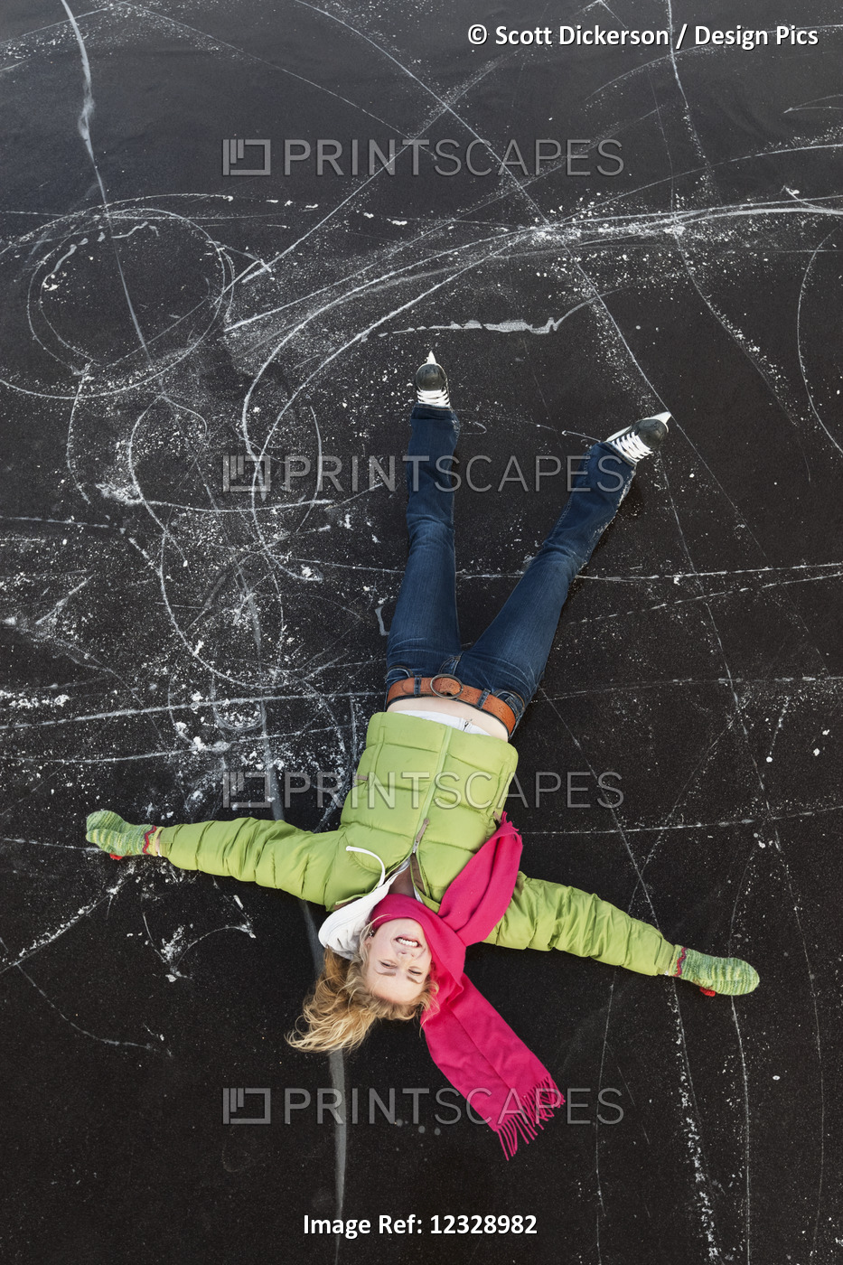 A Young Woman Lays On Her Back On A Frozen Surface Looking Up While Ice ...