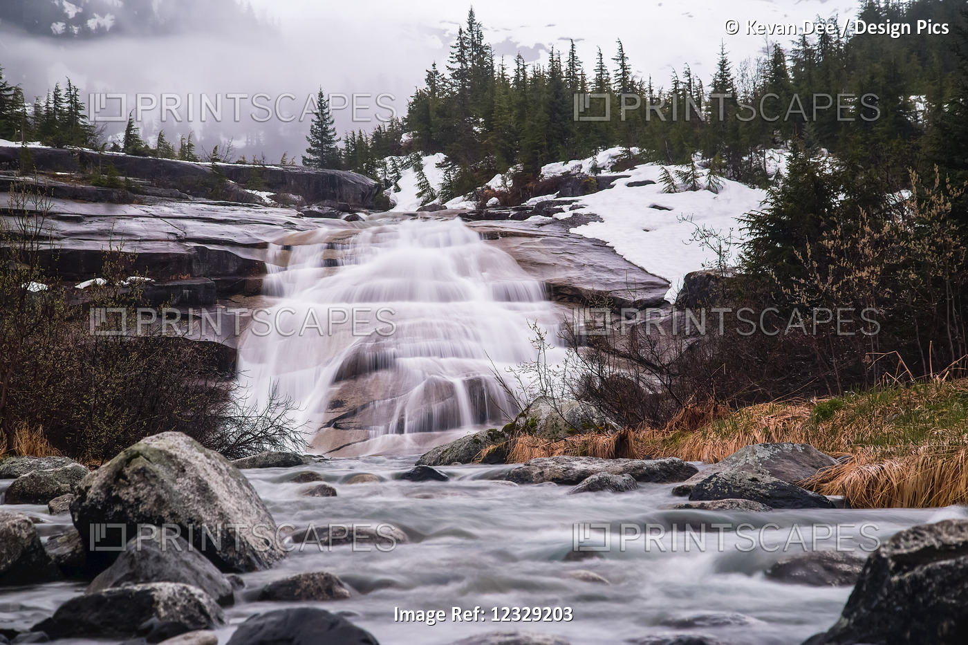 Waterfall Down Rock Slab Near Nellie Juan Glacier On Cloudy Day With Snow; ...
