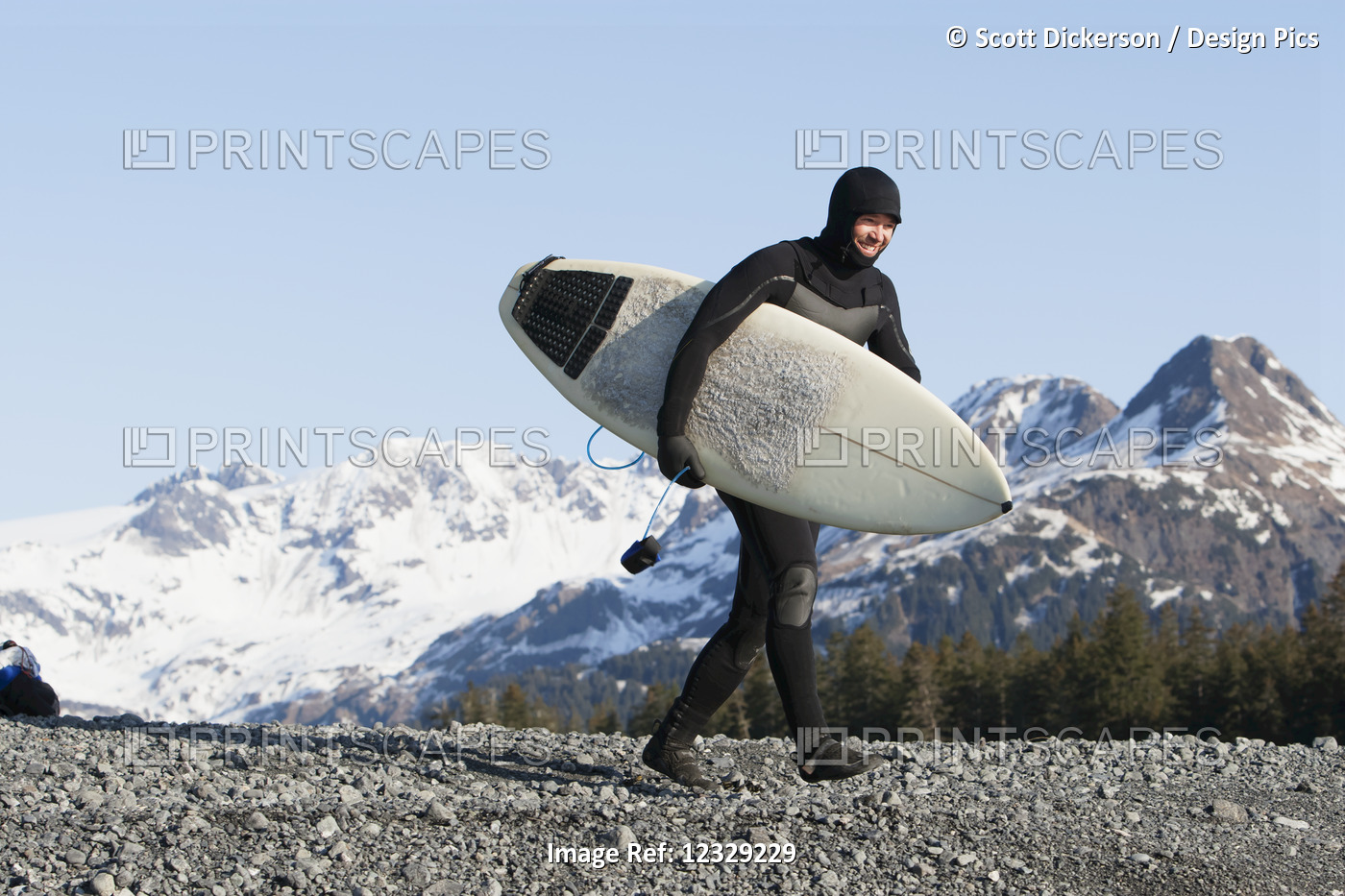 Man walking with a surfboard, Kenai Peninsula Outer Coast, South-central ...