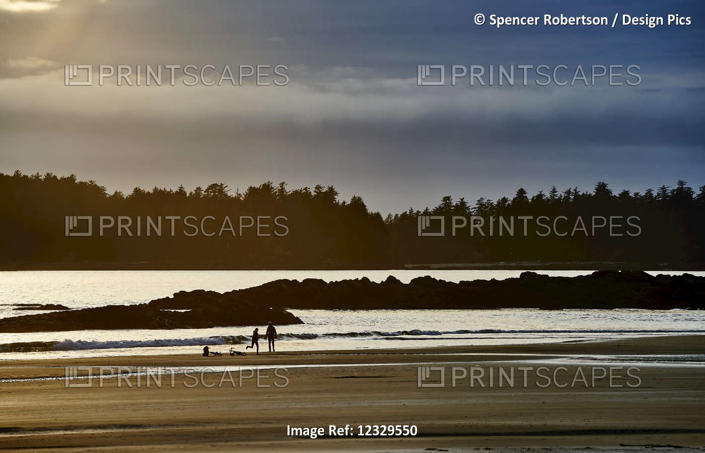 Silhouette Of A Couple And Their Bikes On Mackenzie Beach At Sunset; Tofino, ...