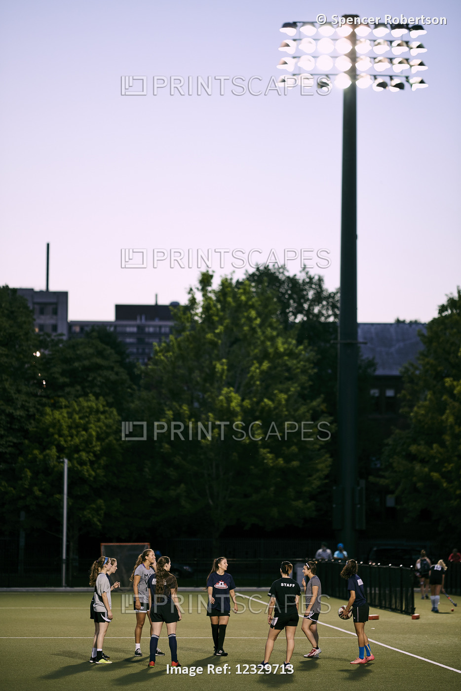 Sports Team Practice On A Field On The University Of Toronto Campus At Dusk; ...
