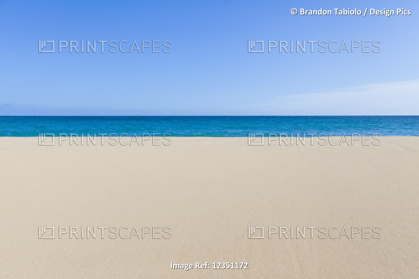 A stunning layered beachscape view of smooth sand, ocean and sky on the North ...