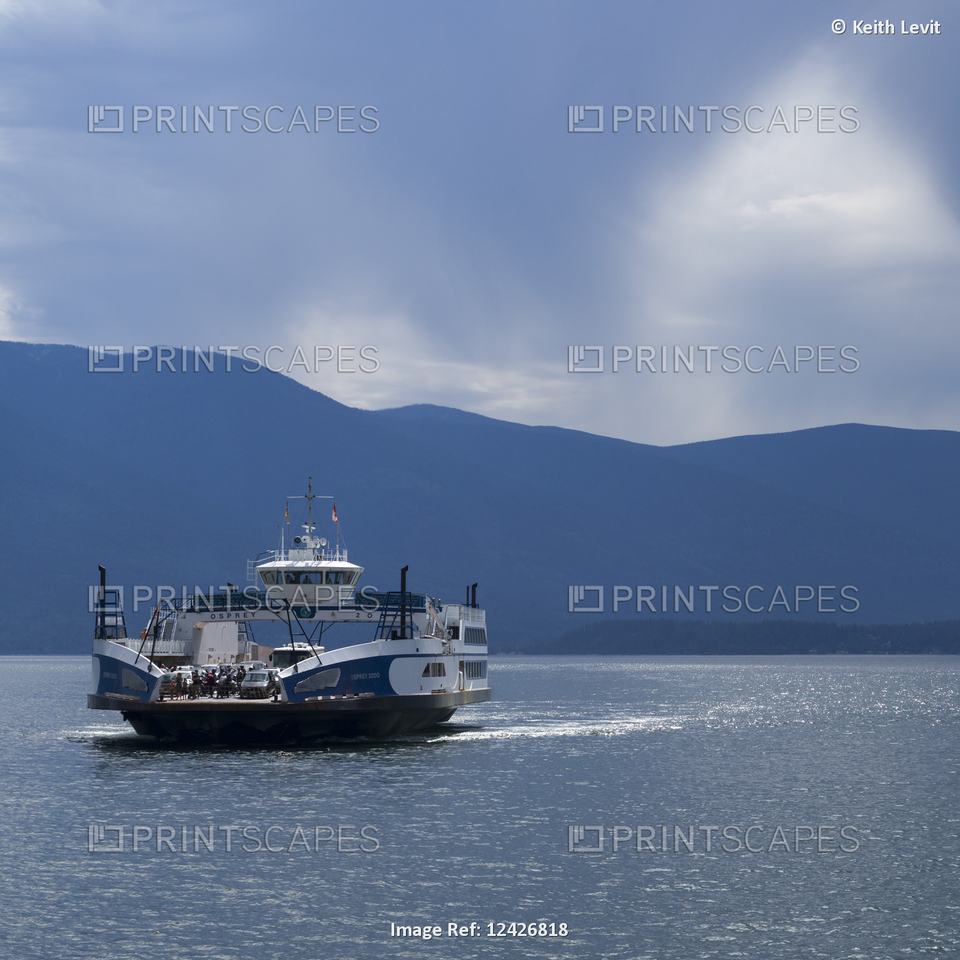 A ferry transports vehicles and people across Kootenay Lake from Kootenay Bay ...
