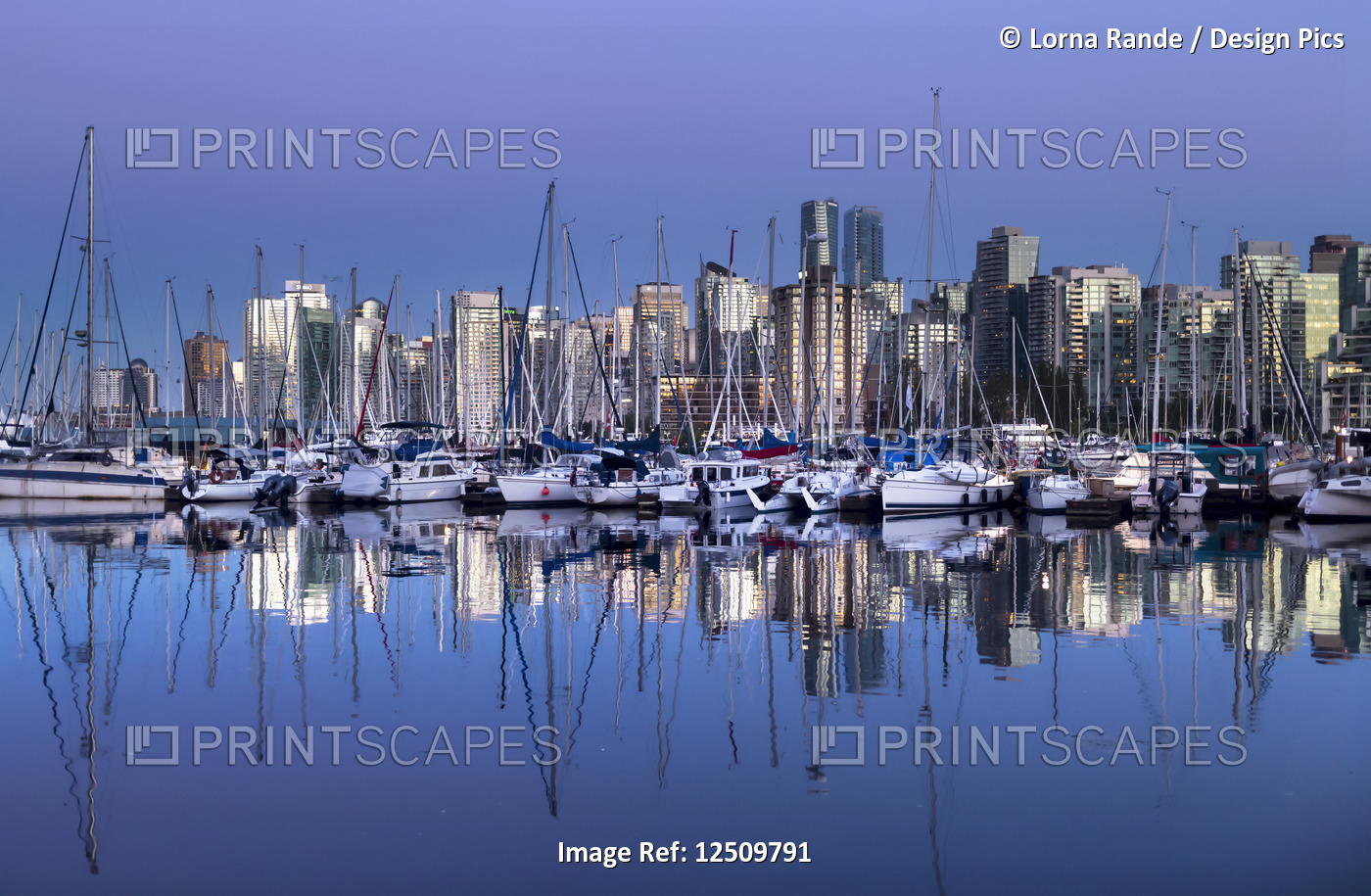 Skyline and harbour of Vancouver at twilight with reflections in the water; ...