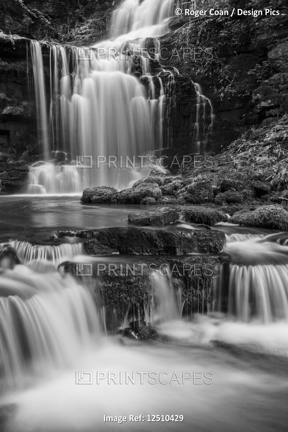Black and white image of numerous waterfalls flowing over rocks in the ...