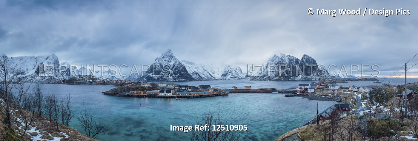 Rugged mountains along the coastline of the Lofoten Islands with turquoise ...