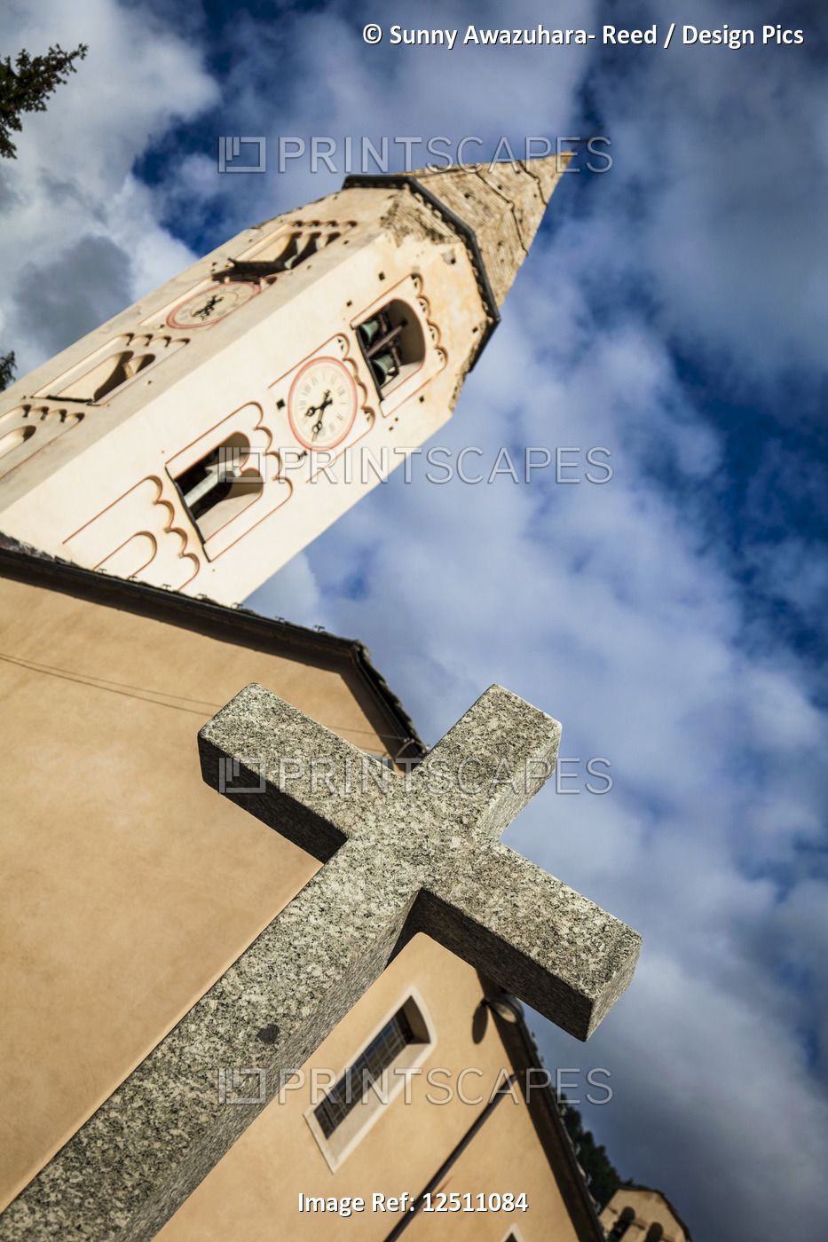 Close-up of stone cross and Church of St. Panteleimon under blue sky; ...