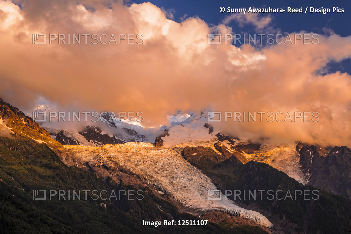 Clouds over Mont Blanc and Bossons Glacier glowing at sunset, Alps; ...